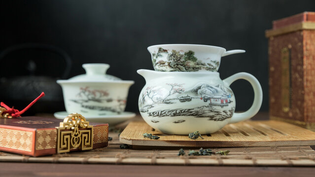 Gaivan and chahay with green tea  
 and tea brew on a brown background. Tea ceremony.  Traditional chinese tea utensils. 