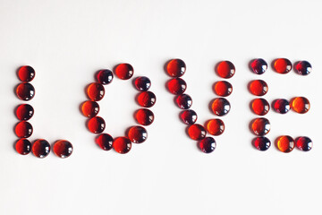 love text with red beads