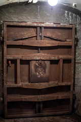 Dark corridor with low lighting and airtight door. Old abandoned bunker. Rusty hermetic door. Underground building.