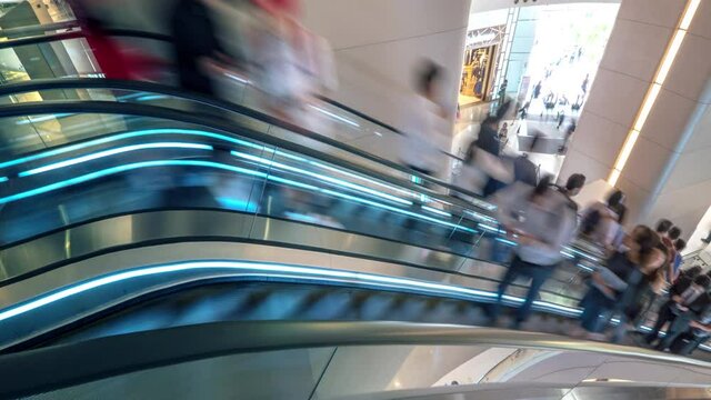 Rush hour timelapse of people move fast on escalator in shopping mall. Urban scene timelapse