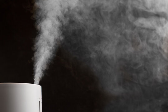 Modern air humidifier on black background
