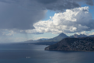 scenic rain clouds over the mediterranean sea and mountains near the coast 