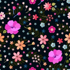 Beautiful seamless floral ornament on a complex background. Tiny and larger flowers and berries are freely arranged in a soothing pattern of dark green leaves against a black backdrop.
