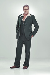 He's a show biz bigshot. Full length studio portrait of a mature man in a retro suit striking a...
