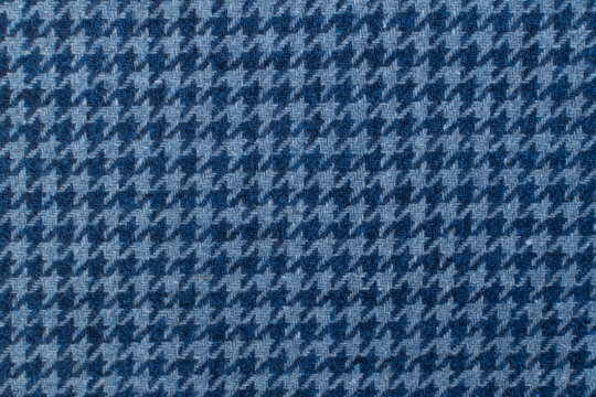 Classic tweed, Wool Background Texture. Coat close-up. Expensive men's suit fabric. Glenurquhart check is made of woolen fabric with a woven twill design of small and large checks. Houndstooth seamles