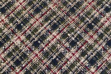 Green checkered fabric with colored threads. Scottish wool. Fabric for a plaid coat and suit....