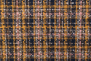 Red checkered fabric with colored threads. Scottish wool. Fabric for a plaid coat and suit. Close-up. Background