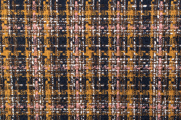 Red checkered fabric with colored threads. Scottish wool. Fabric for a plaid coat and suit. Close-up. Background