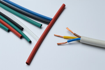 heat shrink tubing and a three-core stripped wire on a white background.