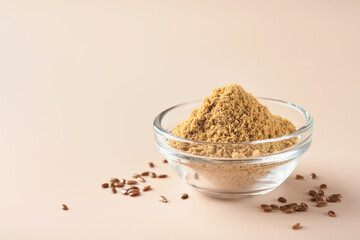 Flax fiber. Ground flaxseeds in glass bowl soluble fiber supplement for intestinal on a beige background. Superfood for healthy. Copy space, free space, space for text.
