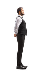 Full length profile shot of an elegant waiter standing