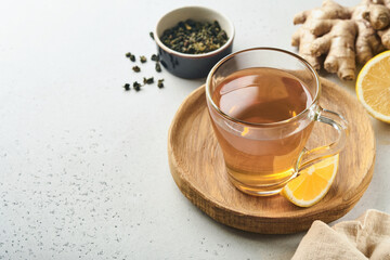 Ginger tea. Cup of ginger tea with lemon, honey and mint on grey background. Concept alternative medicine, natural homemade remedy for cold and flu. Top view. Free space for your text.