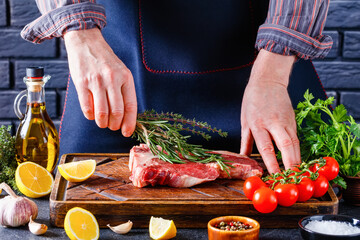 man cooking beefsteak on a kitchen, close-up
