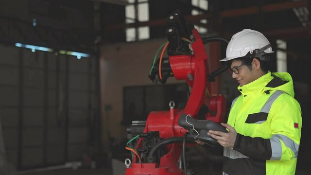 Engineer monitoring system software automation robot in factory Automatic Manufacturing Industry , Welding robotics manufacturing.
