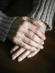 Close up of senior woman hands on table