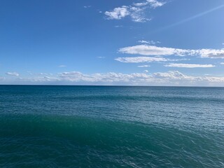 Perfect line of the sea horizon, deep blue sea surface and blue sky