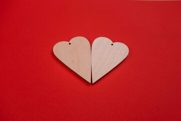Fototapeta premium two wooden hearts on a red background .the concept of Valentine's day and all lovers