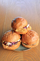 A hamburger (or burger for short) is a food, typically considered a sandwich, consisting of one or more cooked patties—usually ground meat, typically beef—placed inside a sliced bread roll or bun