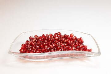 Pomegranate seeds on white background