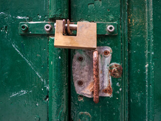 old brass lock on the old green door