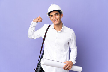 Young architect man isolated on background doing strong gesture