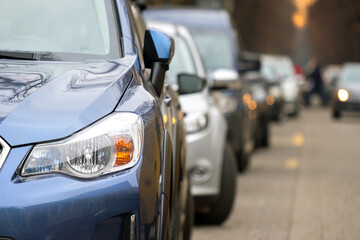 Cars parked in a row on a city street side