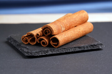 Cassia rolls lie on a slide on a dark stand