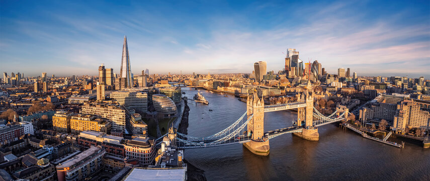 Panoramic Aerial View Of The Skyline Of London With Tower Bridge, River Thames And The City Skyscrapers During Sunrise