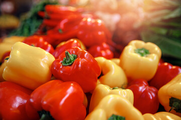 Red and yellow sweet paprika peppers on bazaar counter in Egypt with sunlight. Farm products concept
