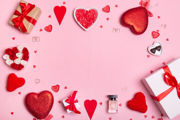Valentine's Day. Frame made of hearts, gifts, candles, confetti on pink background. Valentines day background.
