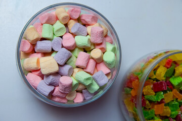 Plate with tasty marshmallows on dark background