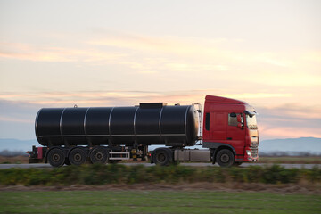 Petrol cargo truck driving on highway hauling oil products. Delivery transportation and logistics...