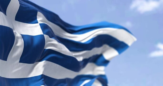Detail of the national flag of Greece waving in the wind on a clear day