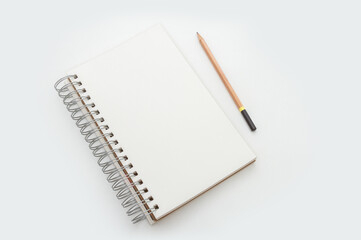 Blank wired sketch drawing pad with pencil on white background