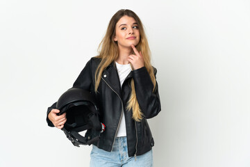 Woman holding a motorcycle helmet isolated on white background looking up while smiling