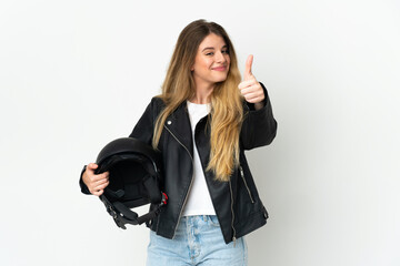 Woman holding a motorcycle helmet isolated on white background with thumbs up because something good has happened