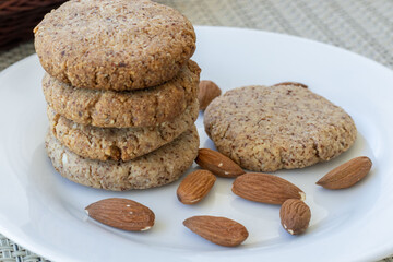 homemade almond cookies stacked in a plate