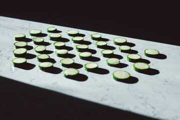 zucchini slices on a table with shadows