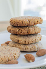 homemade almond cookies stacked in a plate