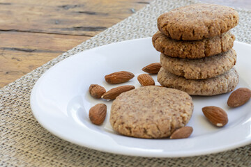 homemade almond cookies stacked in a plate