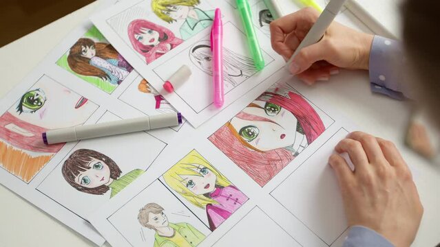 An artist draws a storyboard of an anime comics book. Manga style. The designer animator draws with a watercolor brush with a pen the characters of a color sketch of the cartoon.