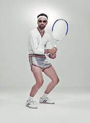 Ready for your serve. Portrait of a young retro tennis player in the studio.