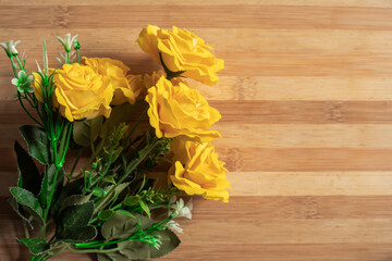 Valentine's Day backgrounds with a bouquet of yellow roses on a wooden table