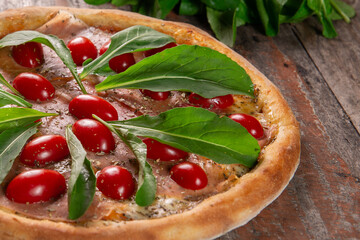 Pizza with Parma ham, arugula and cherry tomatoes