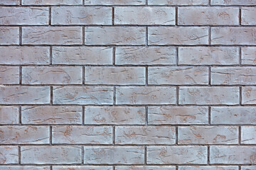The texture of neat brickwork with smoky color tinting on the wall facade closeup.
