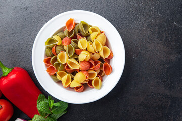 pasta conchiglie colorful mix green, yellow, red broccoli, carrot, beet color healthy meal food snack on the table copy space food background rustic top view