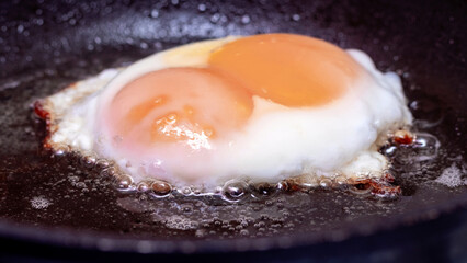 Fototapeta na wymiar Cooking eggs in a pan, the process of frying eggs in a pan