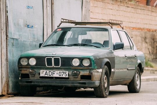 Tbilisi, Georgia - October 21, 2016: Old rusty sedan car BMW 3 Series (E30) parking on street. The BMW E30 is an entry-level luxury car which was produced by BMW from 1982 to 1994.