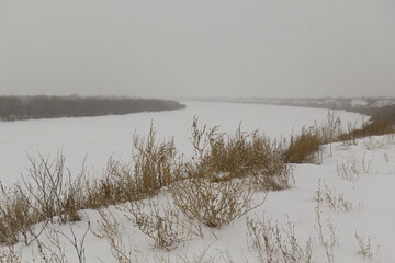 Winter fog over the turn of the northern river.