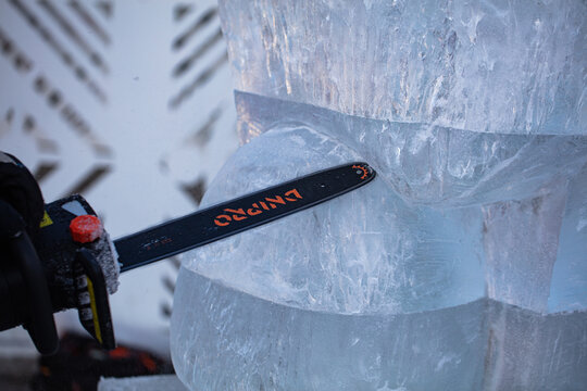 Man Making Ice Sculpture With Dnipro Chainsaw